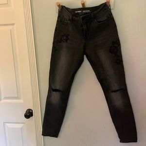Black distressed jeans with floral embroidery accents